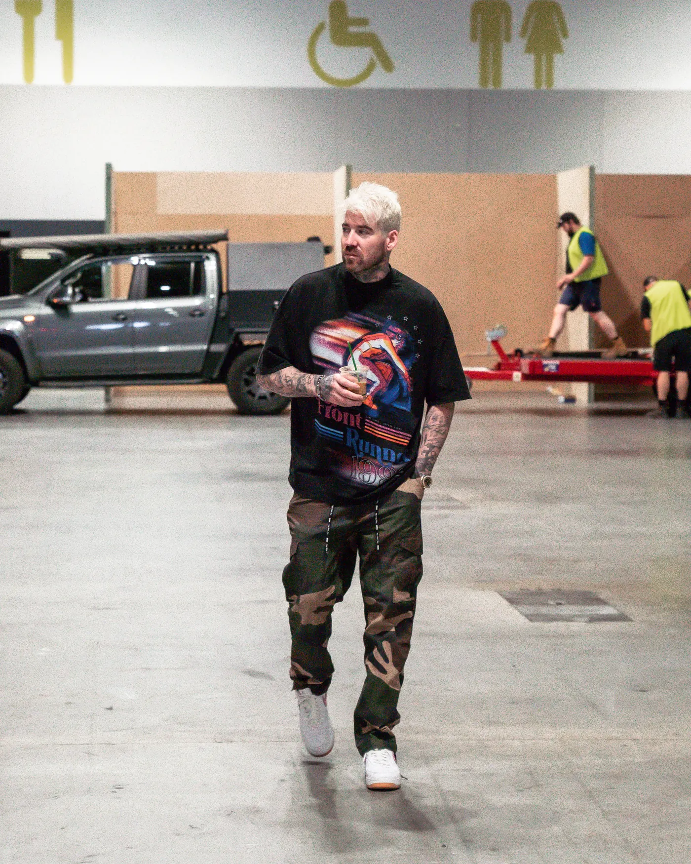 Kevin Mack walking alone across the empty floor of the ICC Sydney
