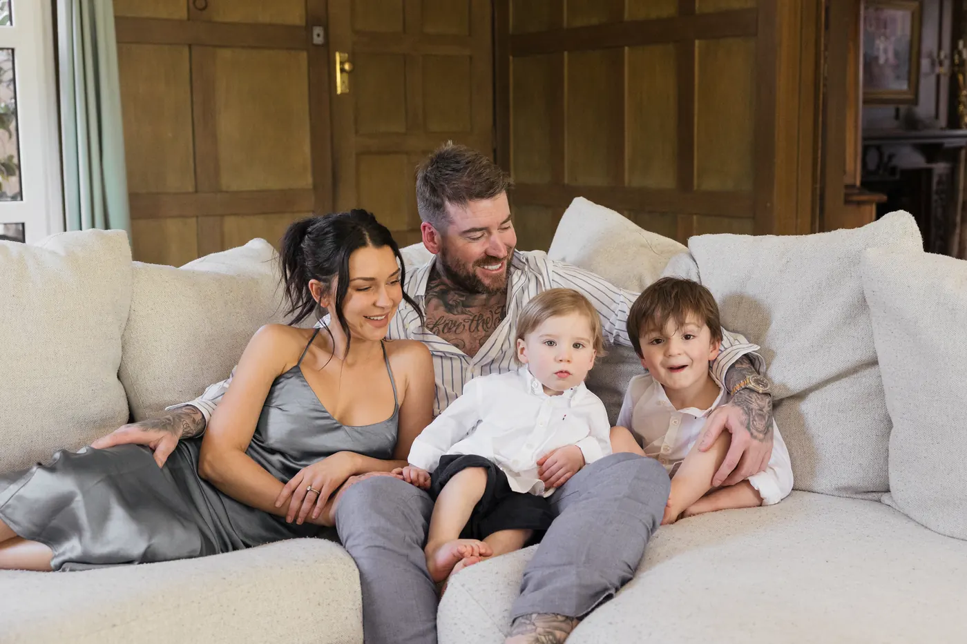 Kevin Mack on a sofa with his wife Shanice and their two sons
