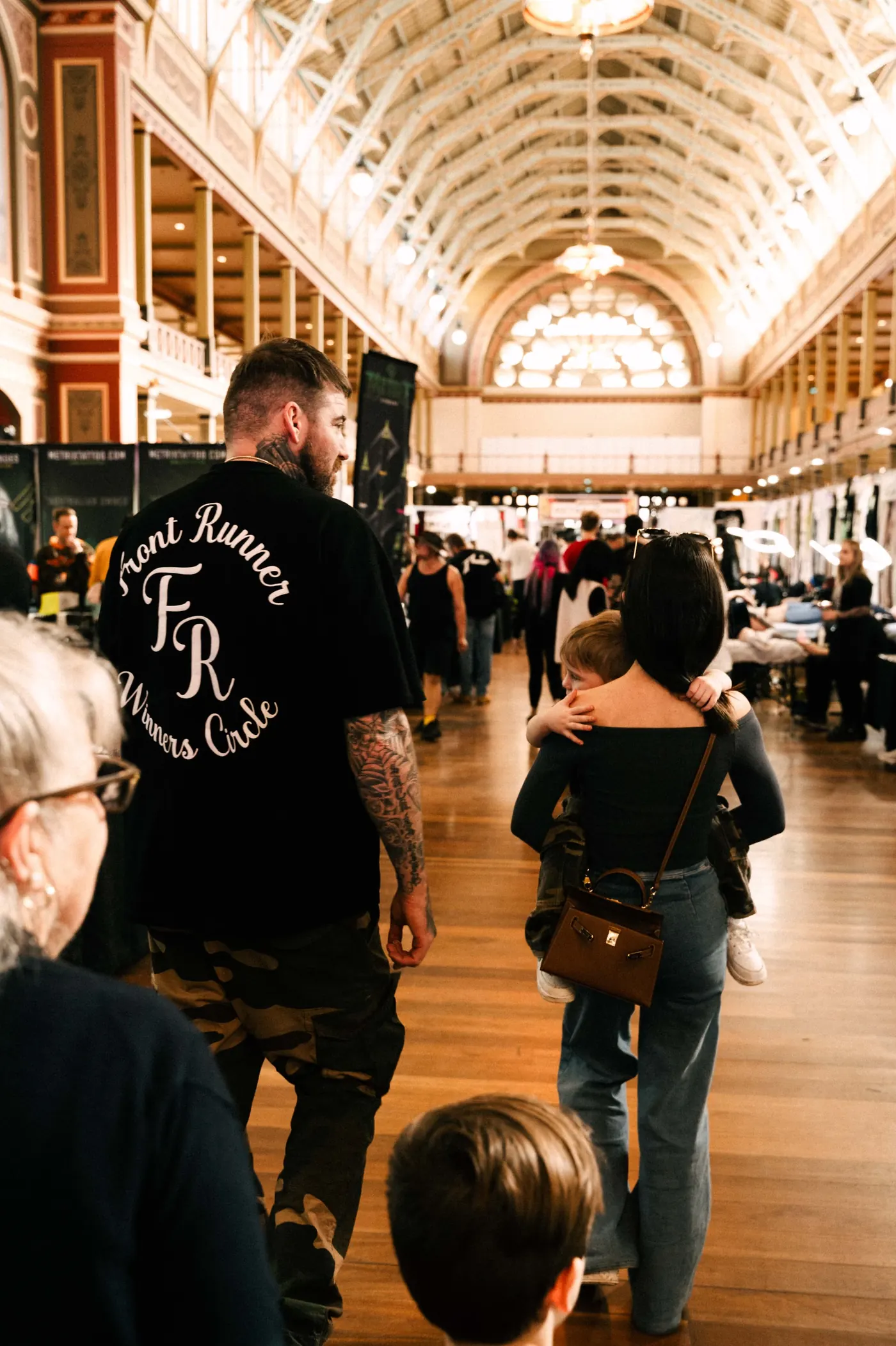 Kevin Mack walking the Royal Exhibition Building floor with his family